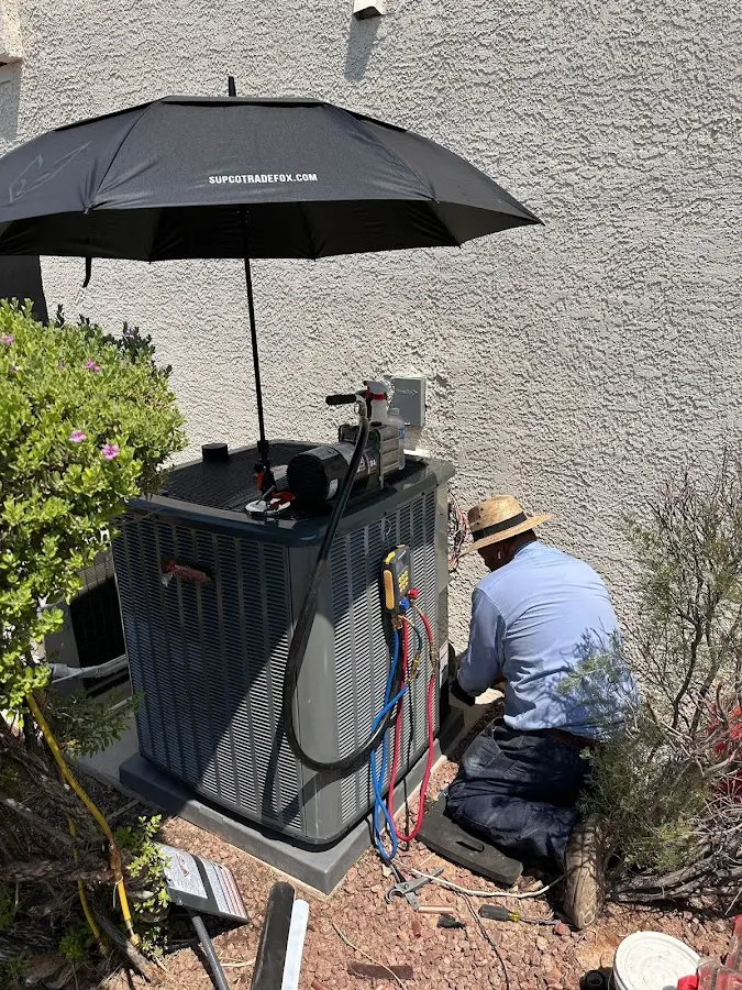 HVAC technician performing outdoor AC maintenance in Tukwila